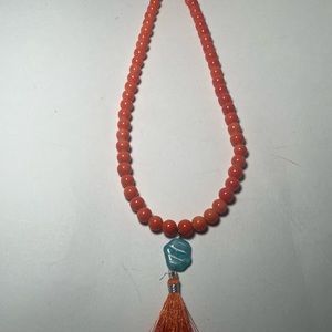 Orange glass beaded necklace with orange tassel pendant